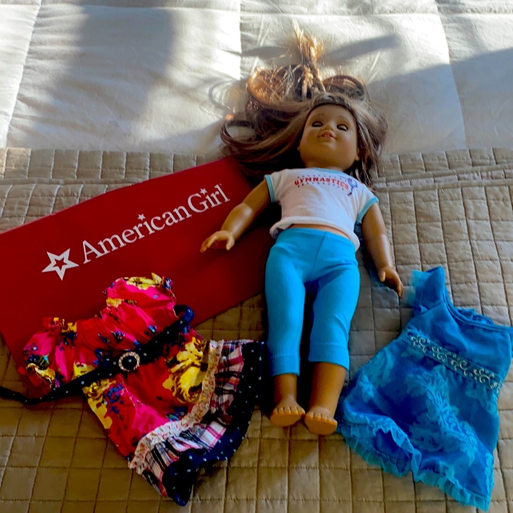 American girl doll and two dresses